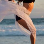 Agile Methodology - Skinny dancer jumping over sandy shore of ocean