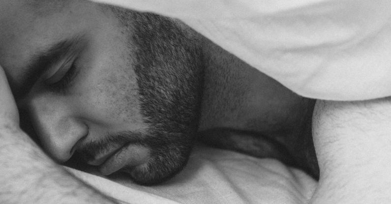 Sleep Routine - Serene man sleeping under blanket