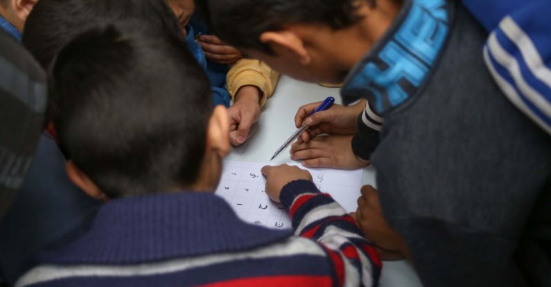 Continuous Learning - Children are writing on a white board