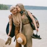 Women Travelers - Photo of Women Embracing While Standing on Beach