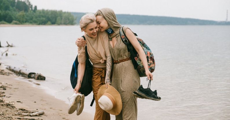 Women Travelers - Photo of Women Embracing While Standing on Beach