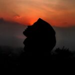 Natural Wonders - Silhouette of person against sunset sky