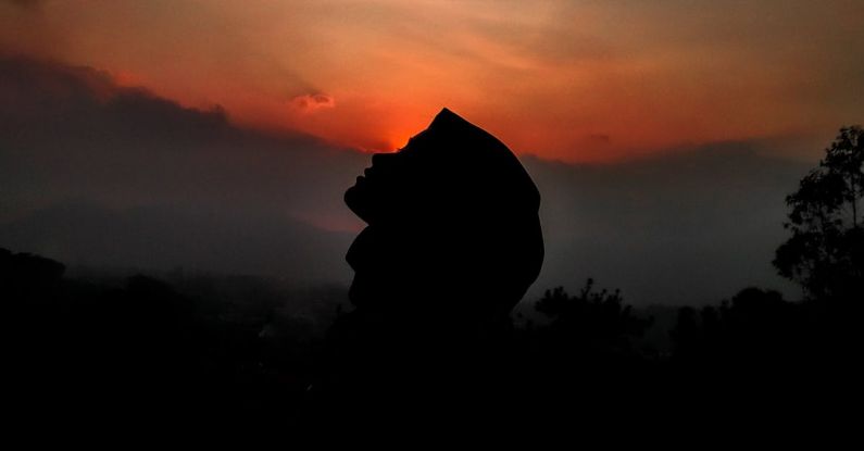Natural Wonders - Silhouette of person against sunset sky