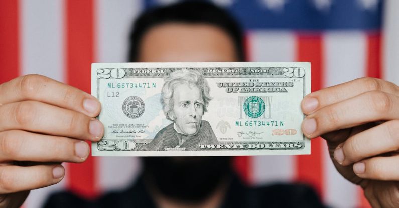 Personal Debt - Unrecognizable man showing 20 American dollars